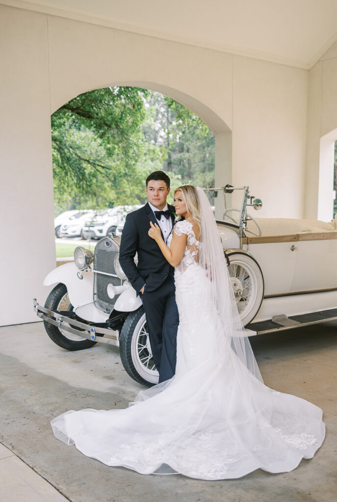 bride and groom with getaway car at the peach orchard venue
