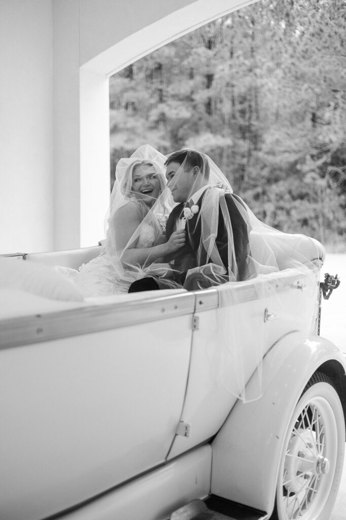 bride and groom in getaway car at the peach orchard venue