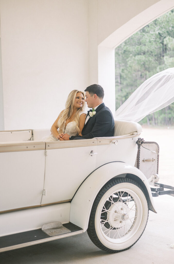bride and groom in getaway car at the peach orchard venue